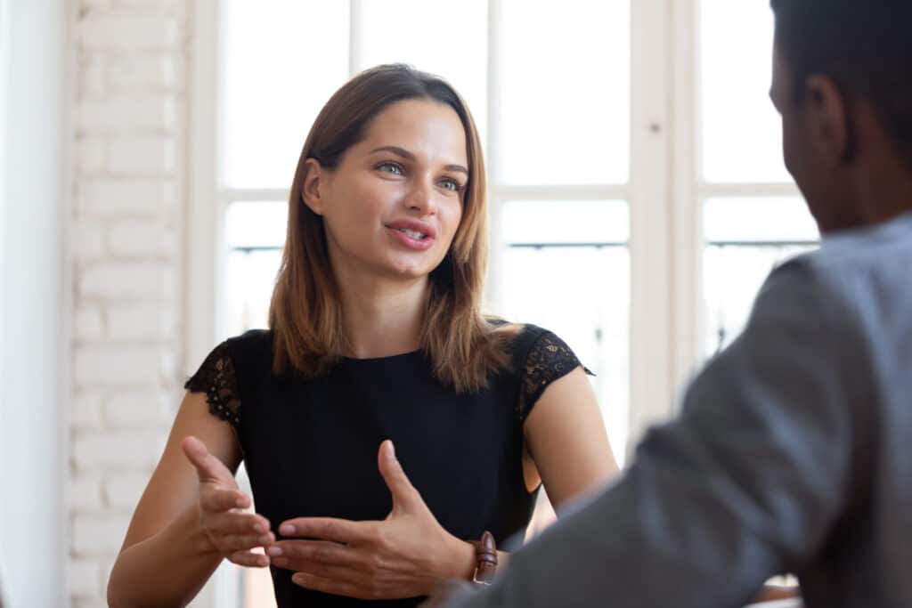 Young woman explaining things to customer