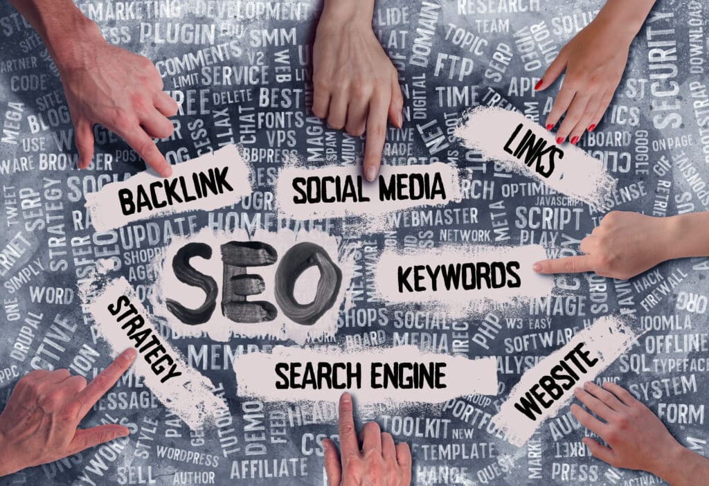 Many SEO related terms written out with fingers pointing to them.